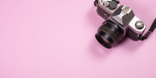 Vintage Camera on pink background,Travel concept