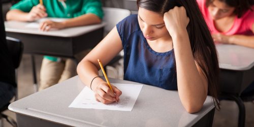 Group of high school students taking a test in a classroom